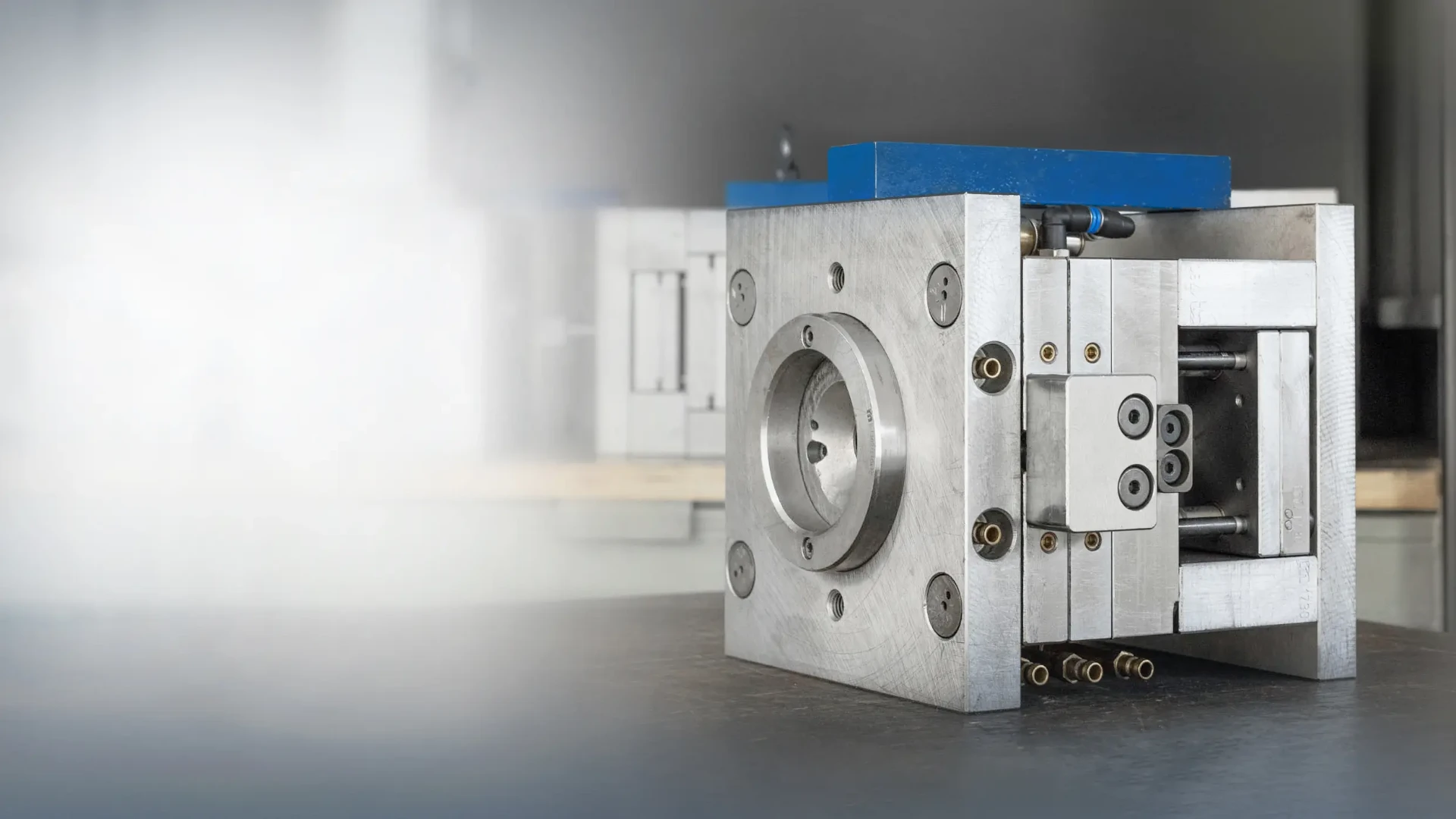 Injection moulding tool standing on a workshop table