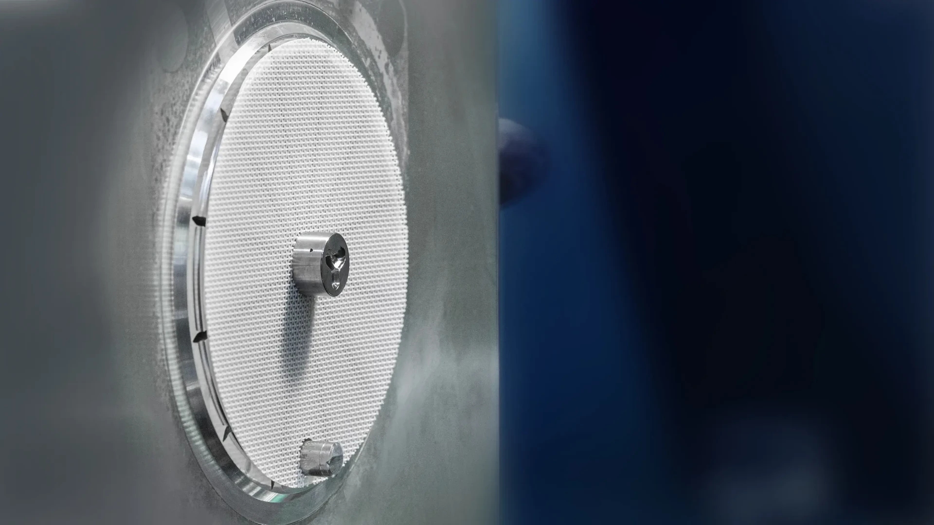 White filter mesh clamped inside the injection moulding tool