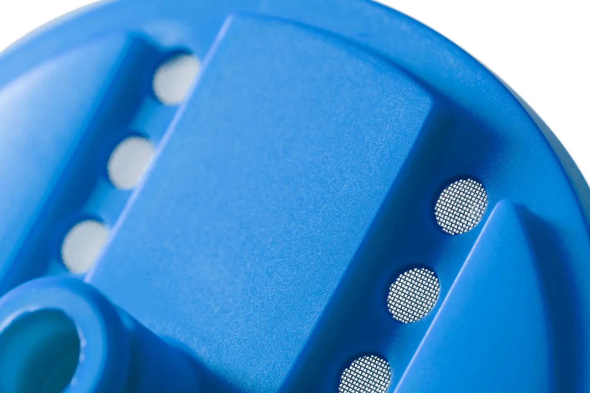 Blue injection moulded filter with overmoulded mesh inserts
